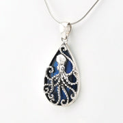 Tear shaped pendant with an octopus design  and blue abalone on a silver snake chain.