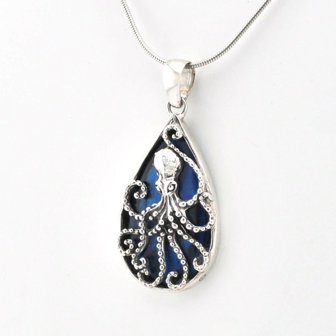 Tear shaped pendant with an octopus design  and blue abalone on a silver snake chain.