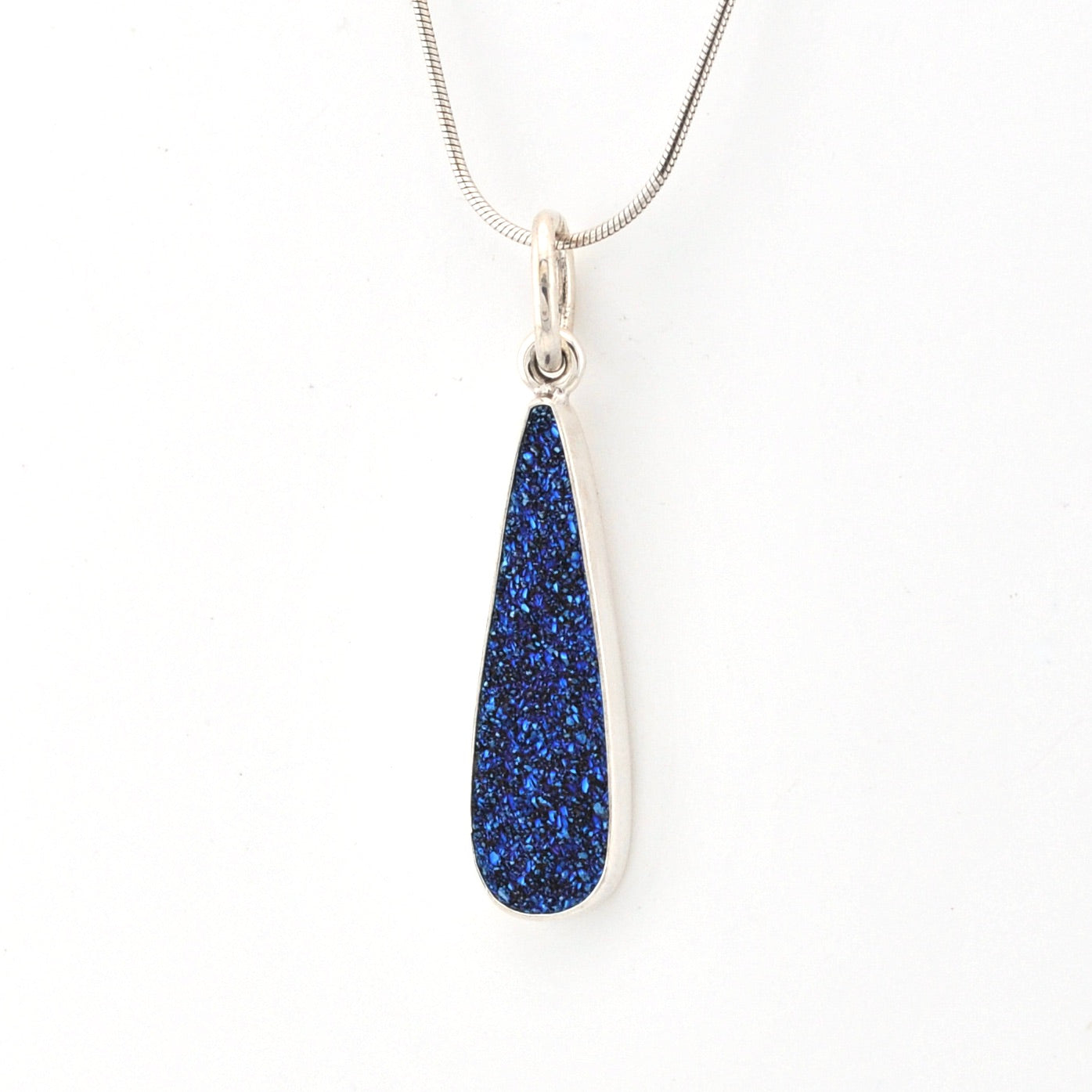 Teardrop-shaped blue pendant on a white background