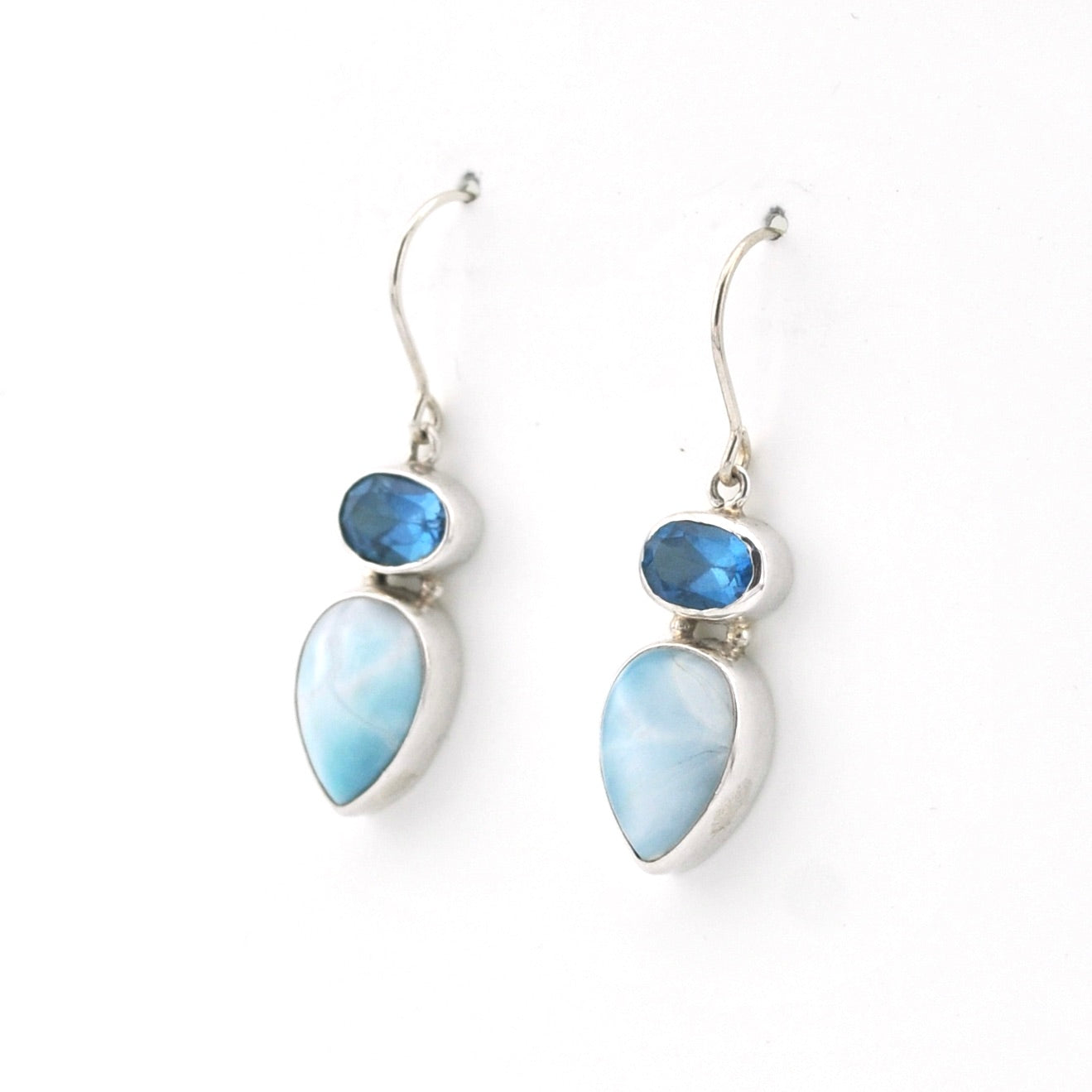 Pair of earrings with blue and white stones on a white background