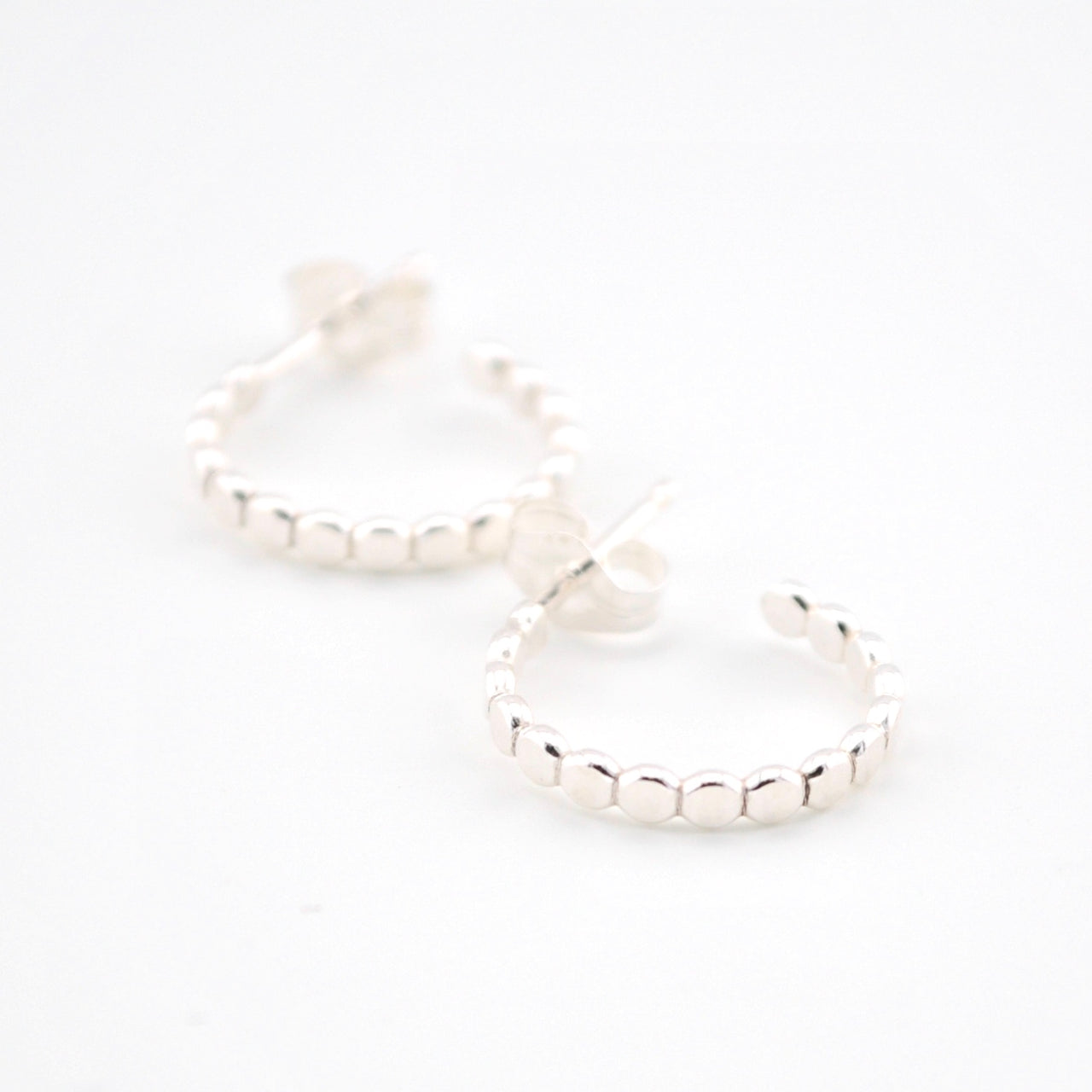 Silver hoop earrings on a white background