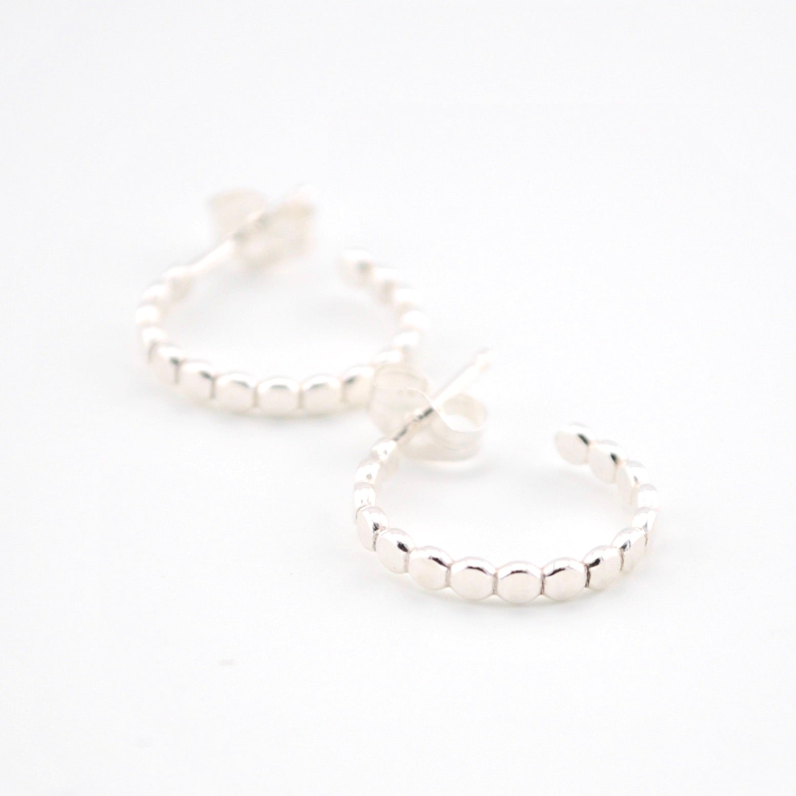 Silver hoop earrings on a white background
