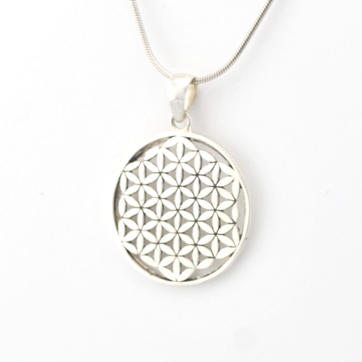 Silver necklace with a geometric pendant on a white background