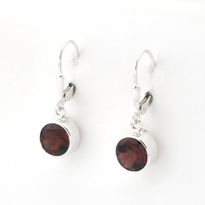 A pair of silver leverback earrings with round dark brown faceted gemstones in silver bezel settings, shown on a plain white background.