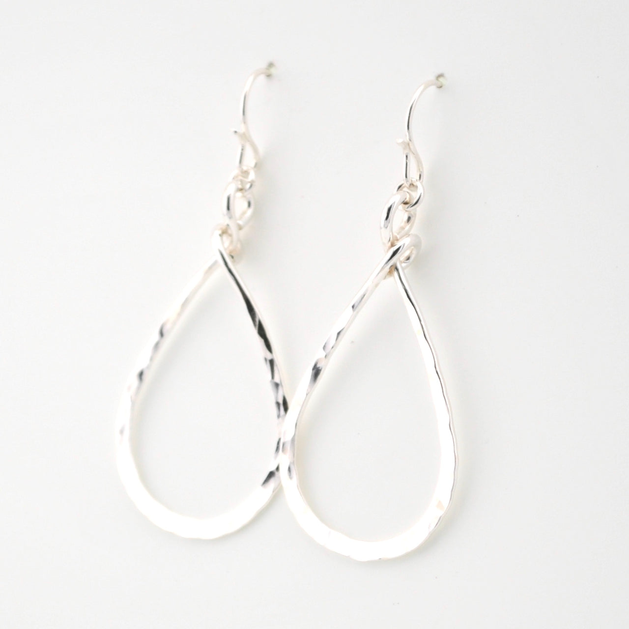 Silver hoop earrings on a white background