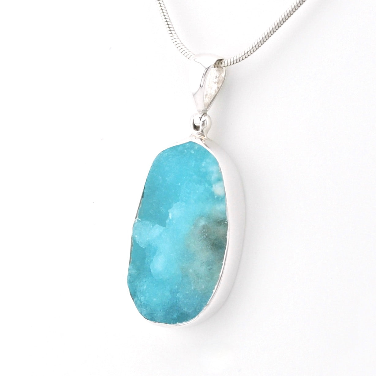 A druzy hemimorphite pendant necklace in a silver bezel setting on a silver snake chain, shown against a plain white background.