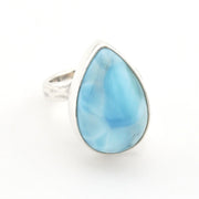 A teardrop-shaped ring featuring a light blue marbled gemstone in a silver bezel setting, with a textured silver band, shown on a plain white background.