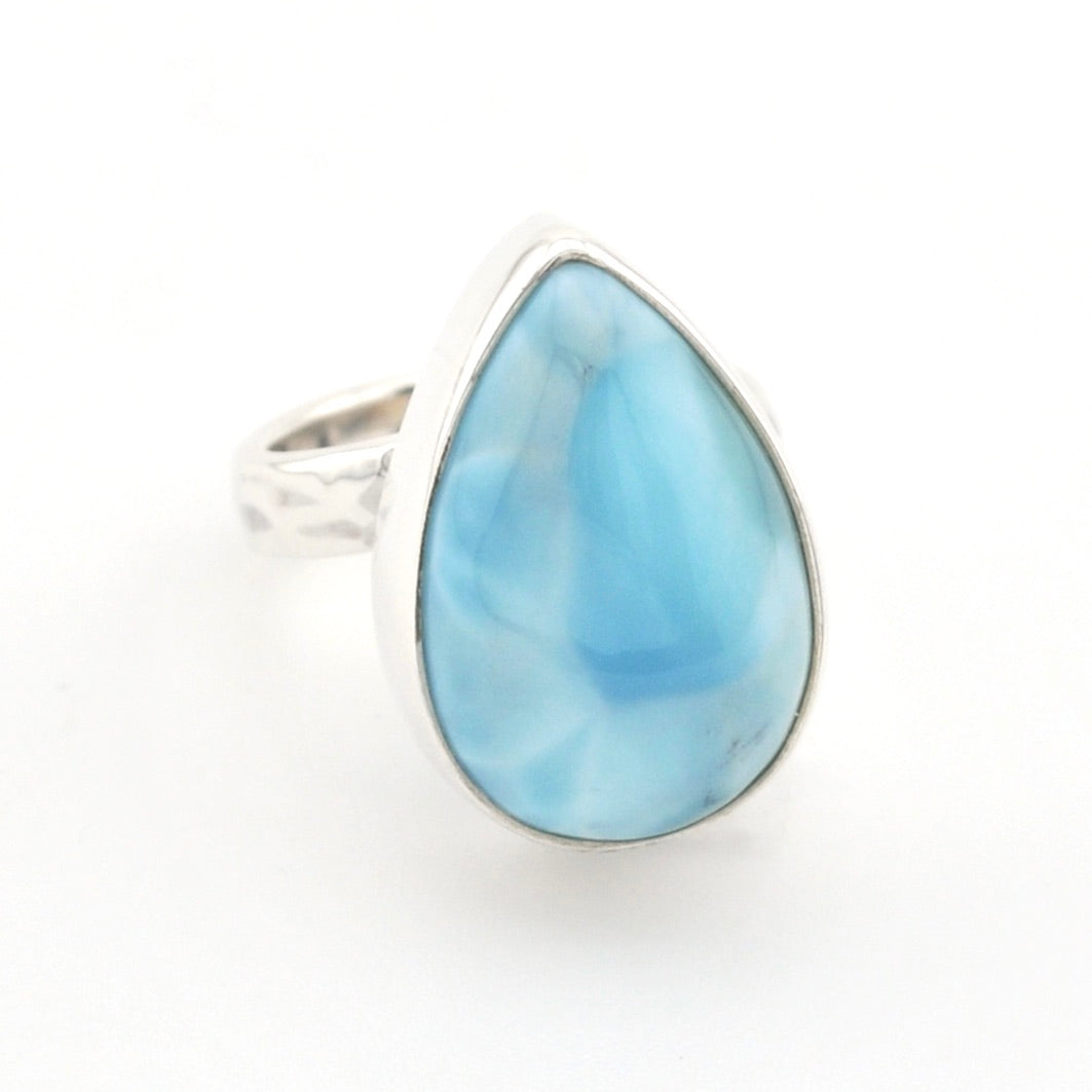 A teardrop-shaped ring featuring a light blue marbled gemstone in a silver bezel setting, with a textured silver band, shown on a plain white background.