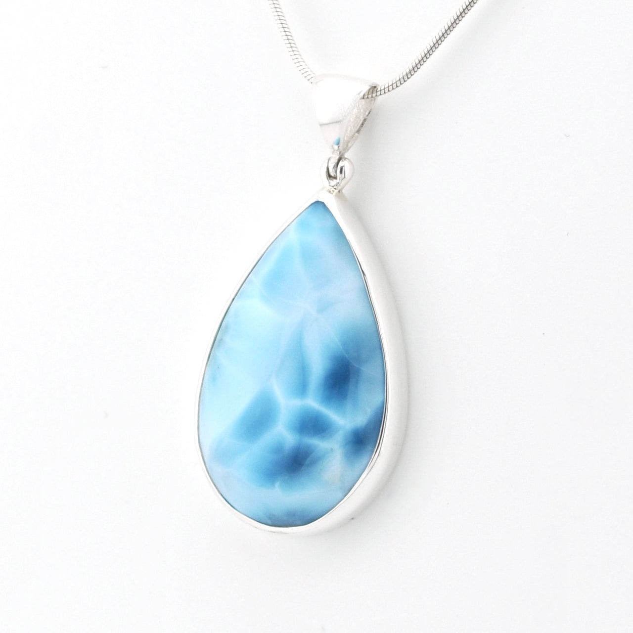 A teardrop-shaped pendant necklace featuring a marbled light blue and white stone in a polished silver bezel setting, suspended from a silver snake chain against a plain white background.