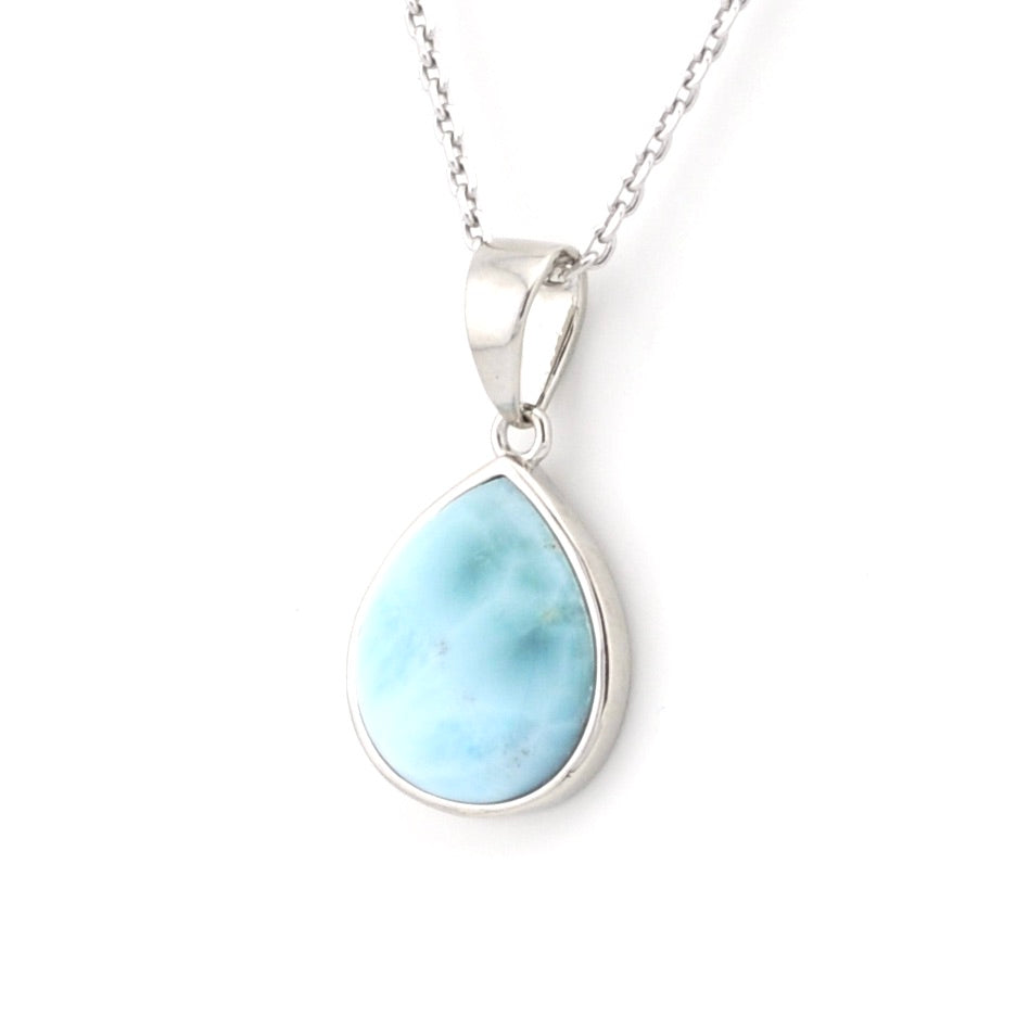 Larimar tear pendant with silver chain on white background.