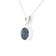 Silver chain with dark blue pendant on a white background