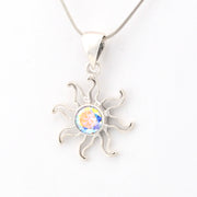 Silver sun-shaped pendant with a colorful center on a white background
