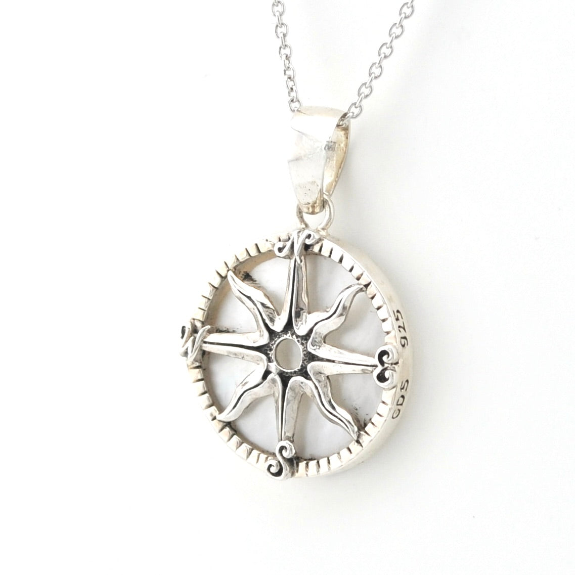 A sterling silver compass pendant necklace on a delicate silver chain, shown against a plain white background.