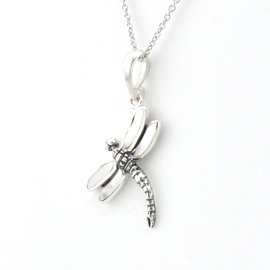 A silver dragonfly pendant necklace on a delicate silver chain, photographed against a clean white background.