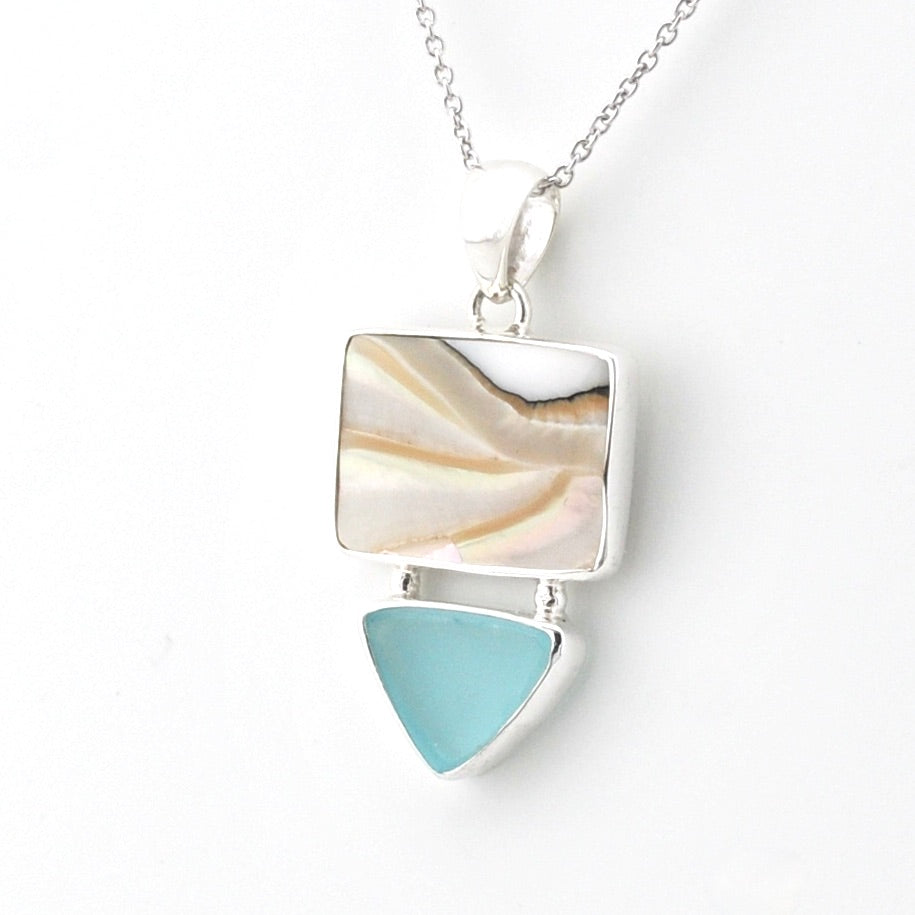 A silver pendant necklace featuring a square nautilus shell with wavy cream and tan patterns, and a dangling light blue teardrop-shaped sea glass, shown on a white background.