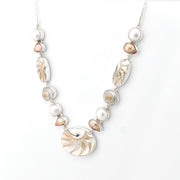 Necklace with shell and pearl beads on a white background