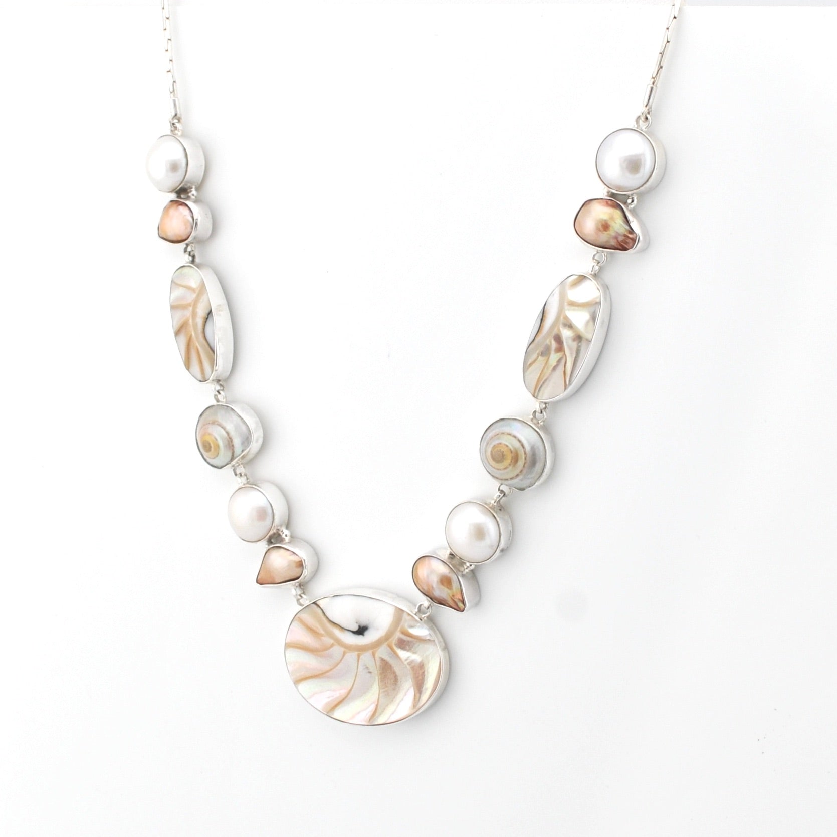 Necklace with shell and pearl beads on a white background