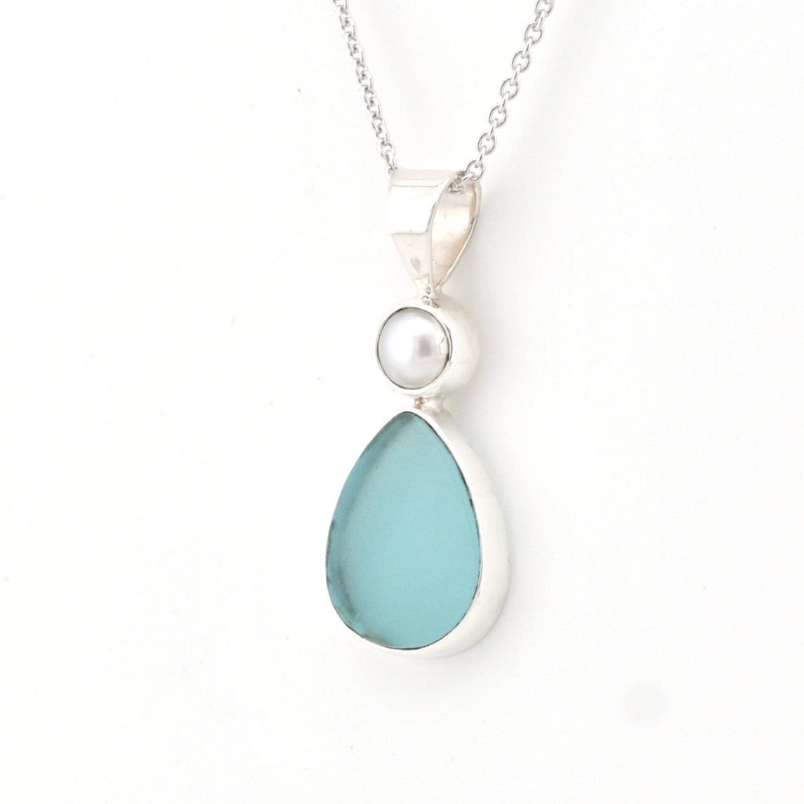 Necklace with a teardrop-shaped light blue pendant and a pearl on a white background