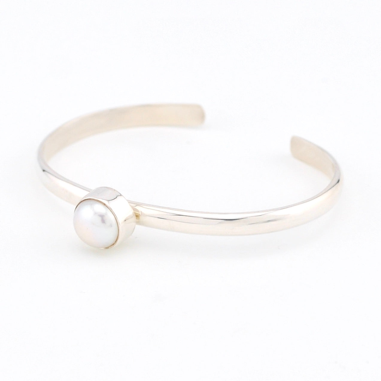 Silver bracelet with a pearl on a white background