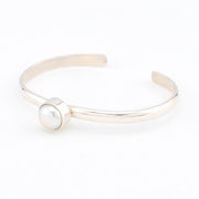 Silver bracelet with a pearl on a white background