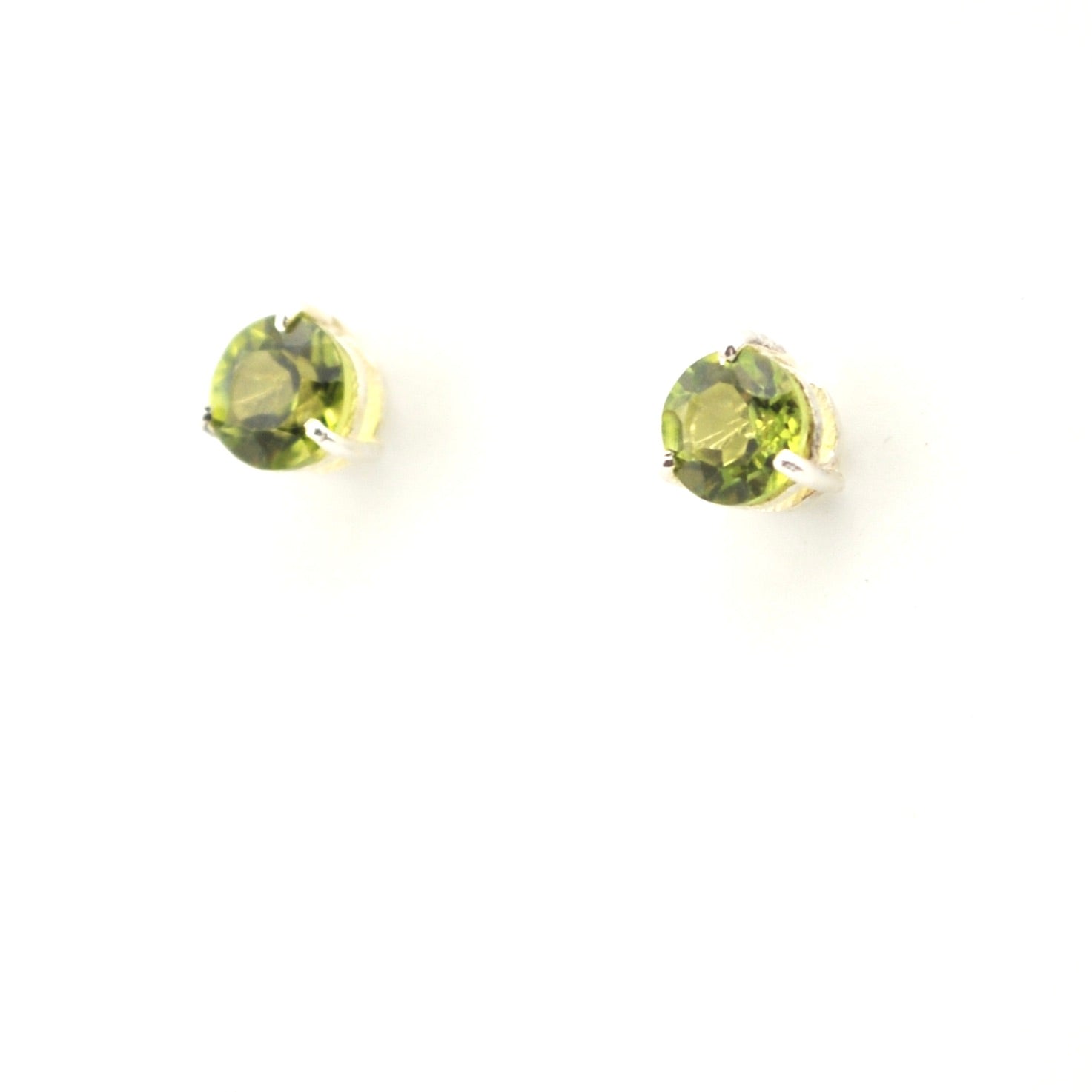 Pair of round green gemstone earrings on a white background