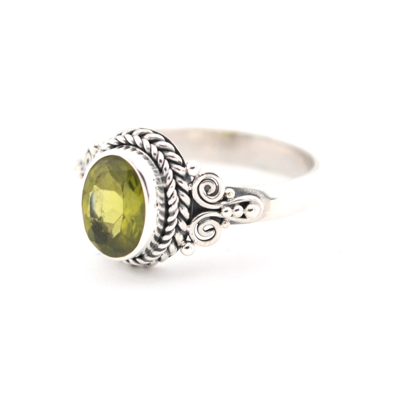 Silver ring with a green gemstone on a white background