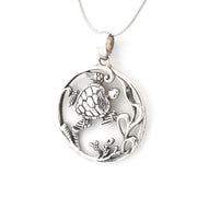 Silver pendant with turtle design on a white background