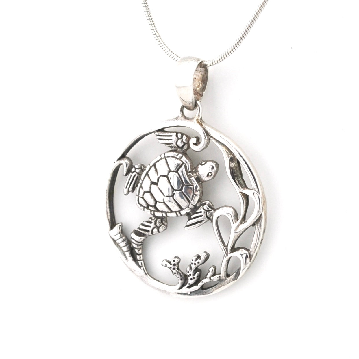 Silver pendant with turtle design on a white background
