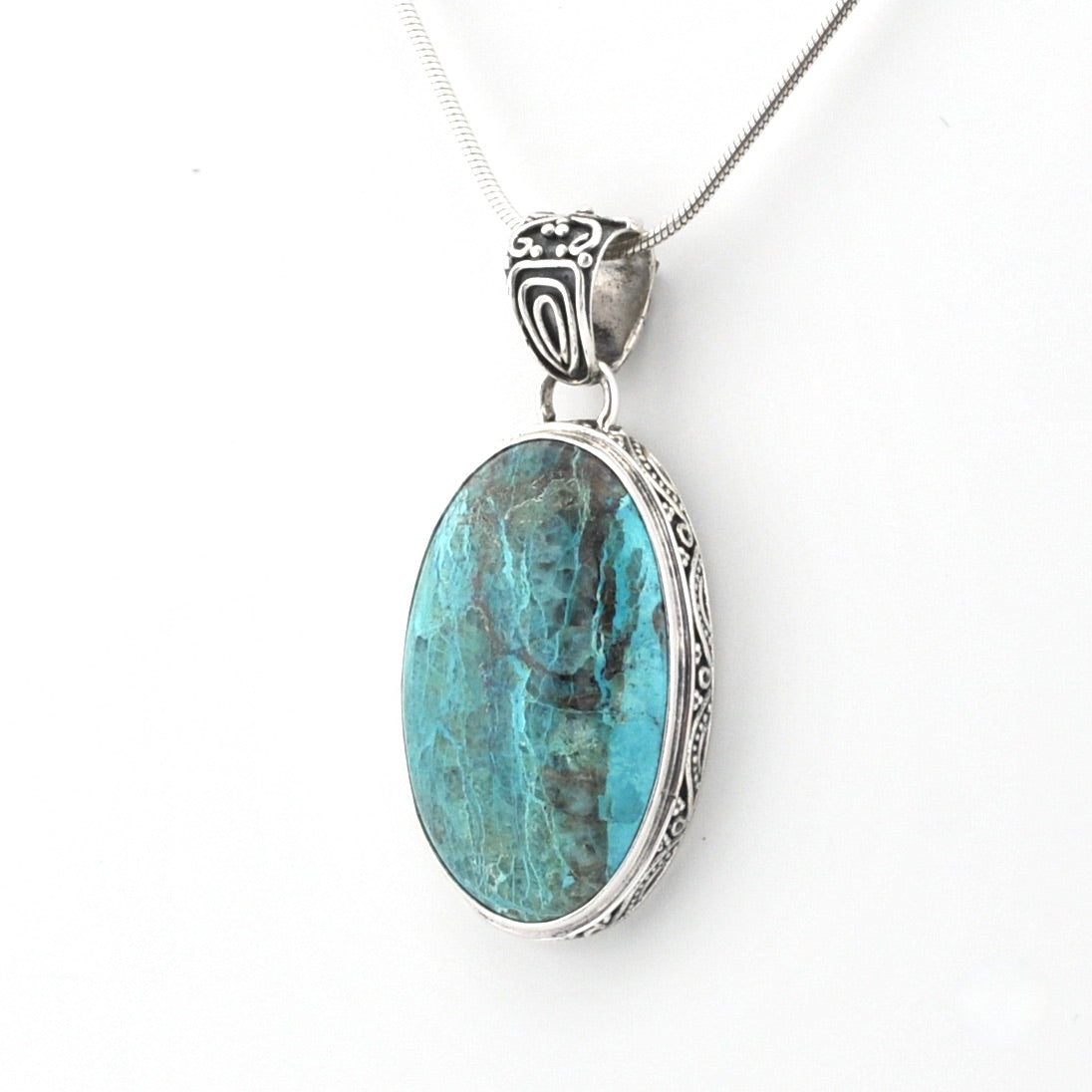 An oval pendant necklace featuring a turquoise-blue marbled stone in a silver-toned metal bezel setting, suspended from a matching silver chain against a plain white background.