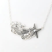 A silver-toned necklace featuring a mermaid and starfish pendant design, suspended from a delicate link chain against a plain white background.