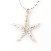 Silver starfish pendant on a white background