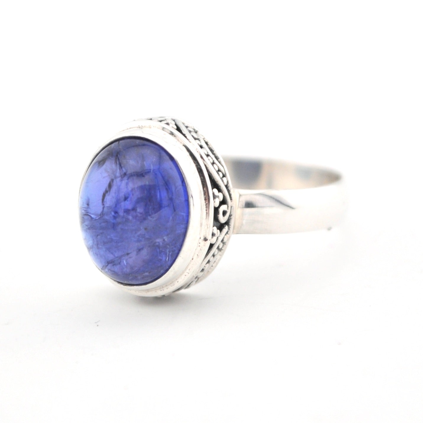 Silver ring with a blue stone on a white background