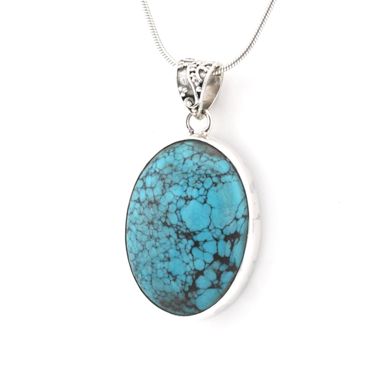 An oval turquoise pendant necklace with a silver-toned bezel and chain, shown against a plain white background.