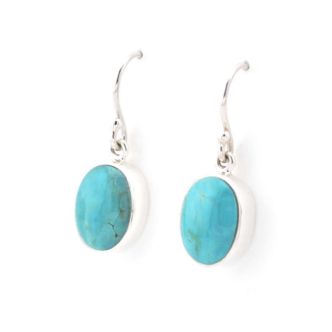 A pair of oval turquoise dangl earrings on a white background