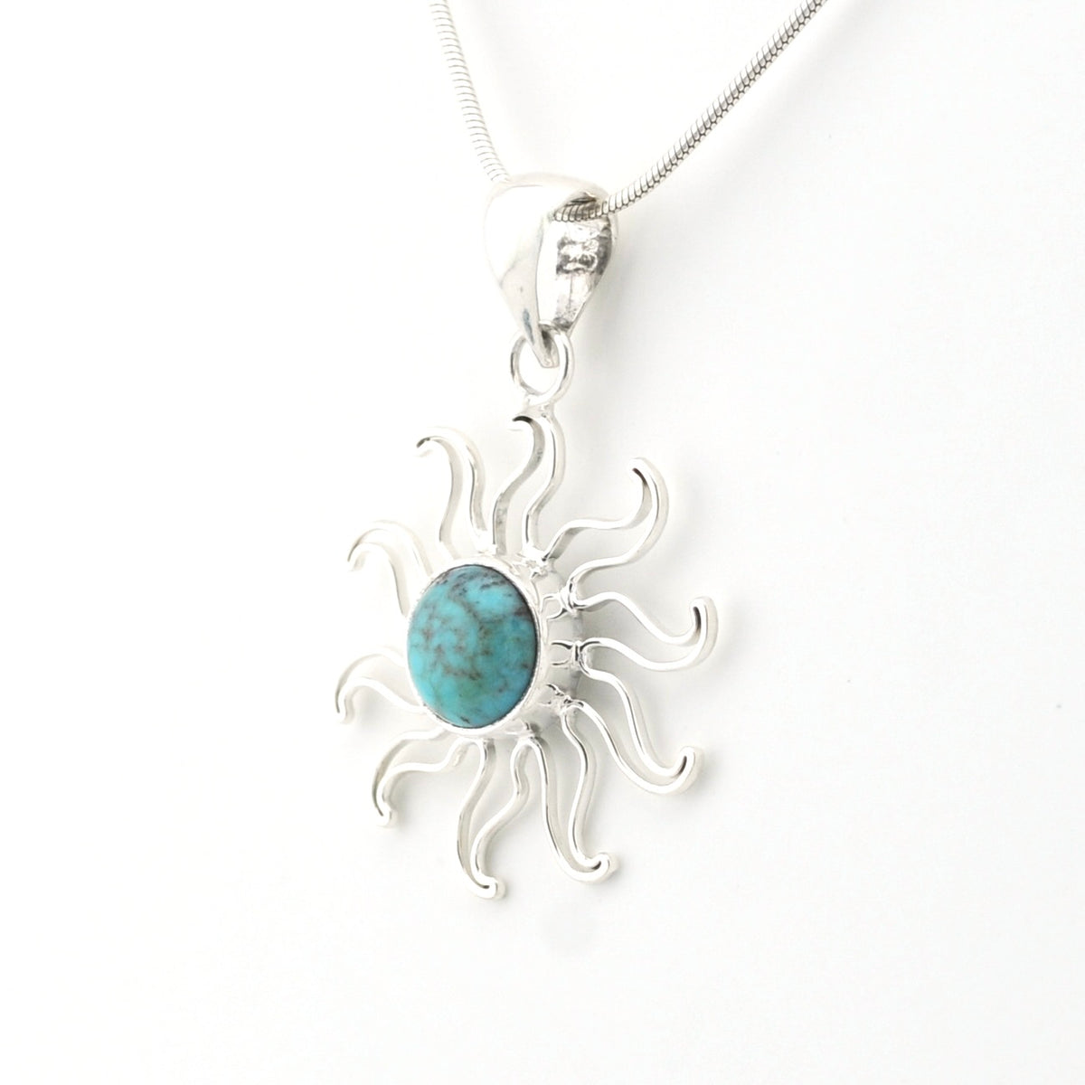 A sterling silver sunburst pendant necklace featuring a central oval turquoise stone, shown on a clean white background.