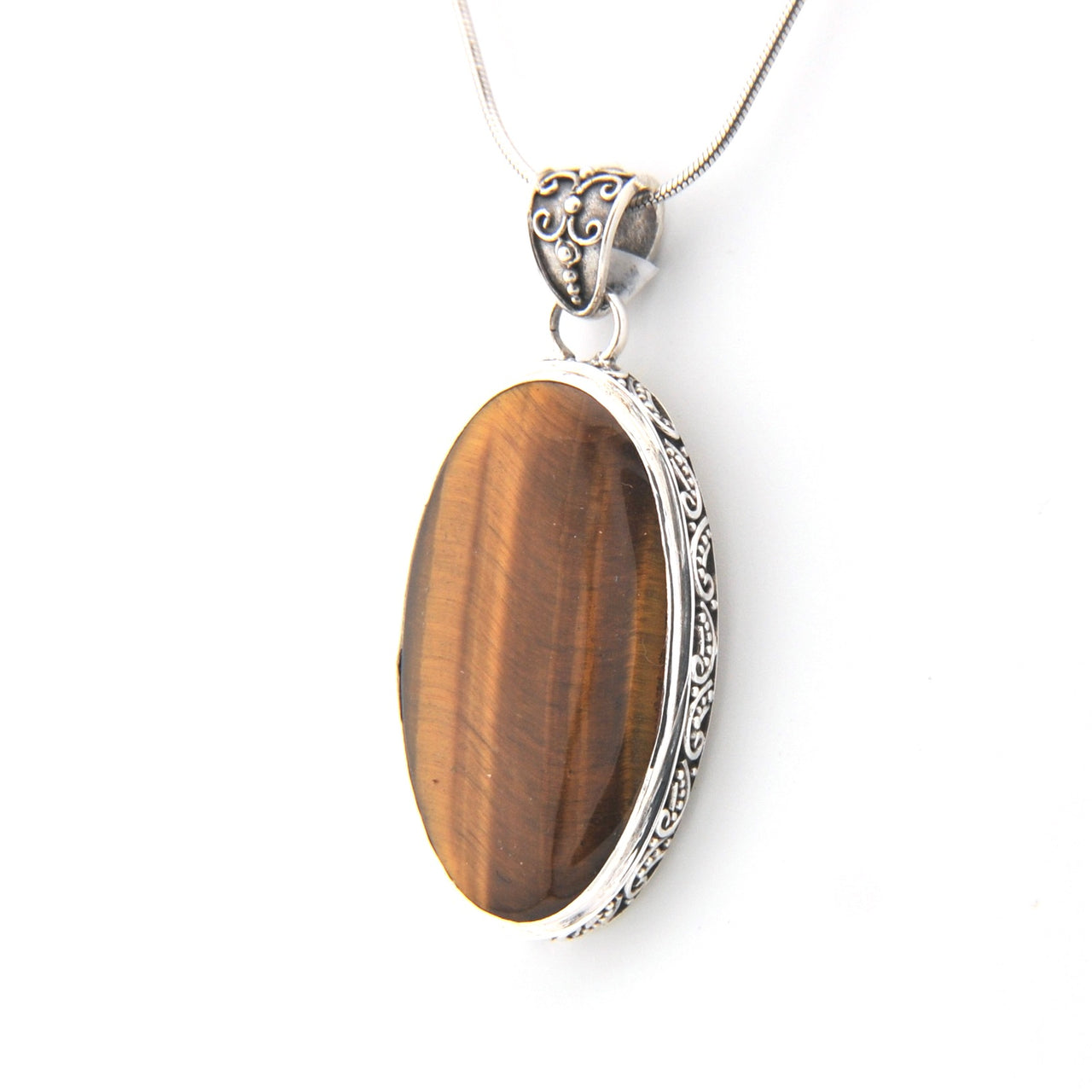 Brown oval pendant with silver frame on a white background