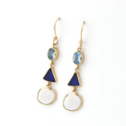 Gold earrings with blue and white stones on a white background