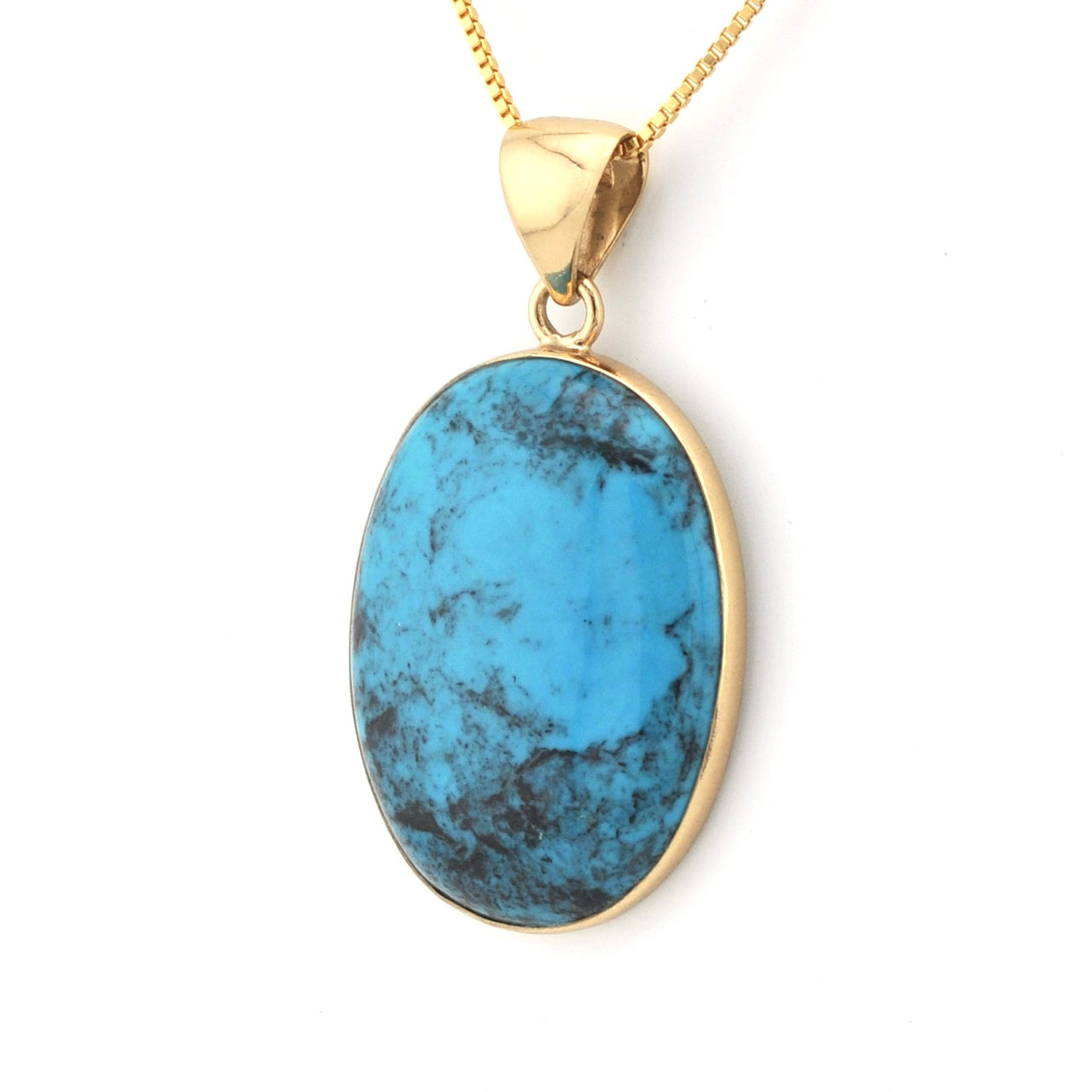 Turquoise pendant on a gold chain against a white background