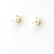Pair of pearl earrings with gold posts on a white background