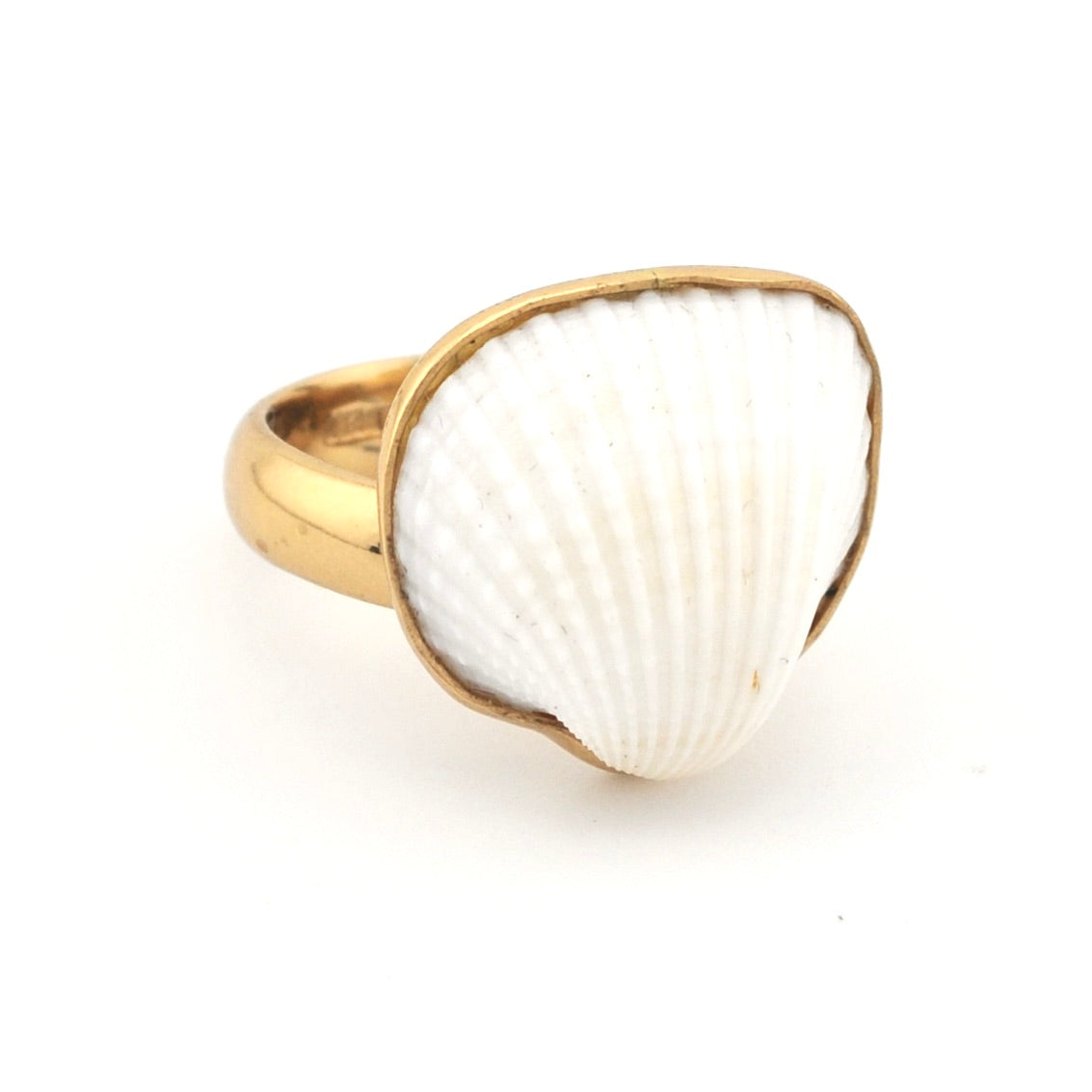 Ring with a white shell inlay and gold band on a white background