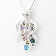 A silver octopus pendant necklace with multiple colorful gemstones, shown on a plain white background.