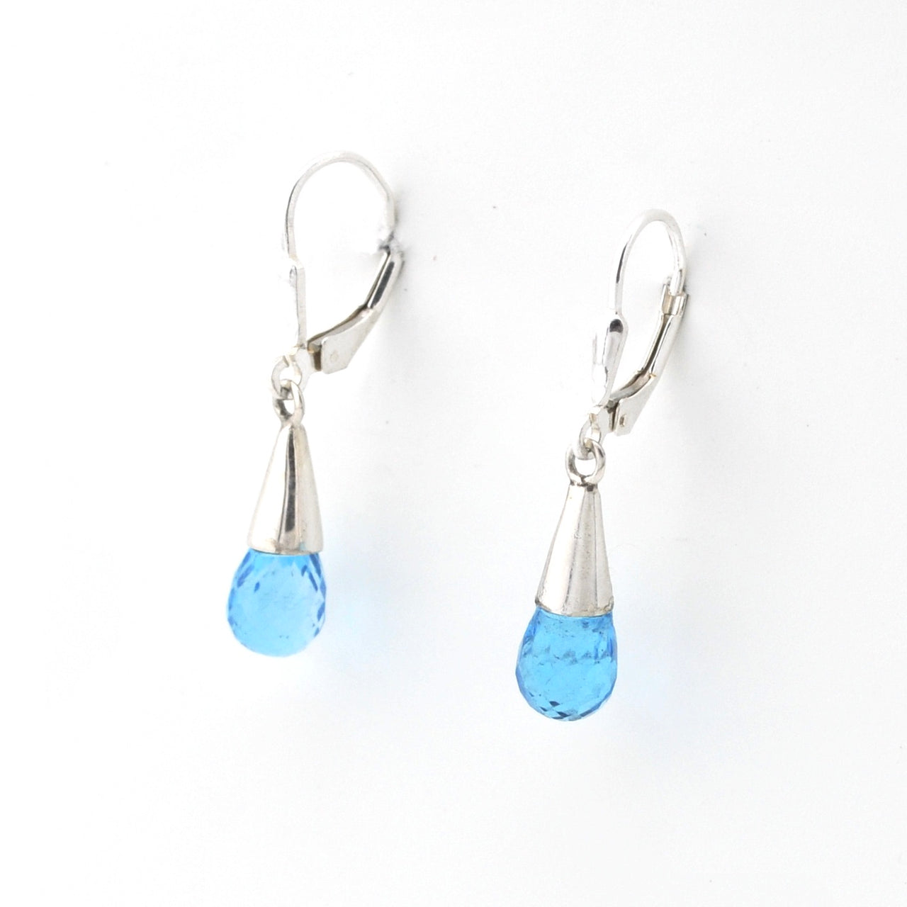 Pair of silver earrings with blue teardrop-shaped drops on a white background