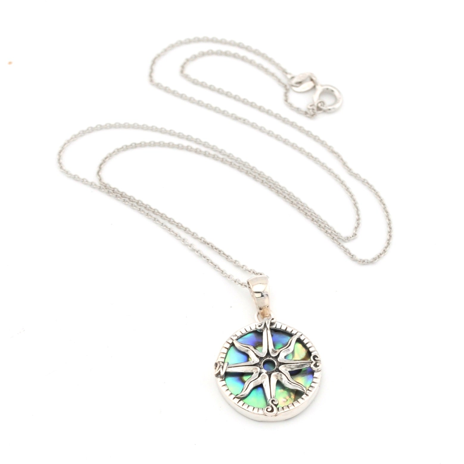 Silver necklace with a colorful pendant on a white background