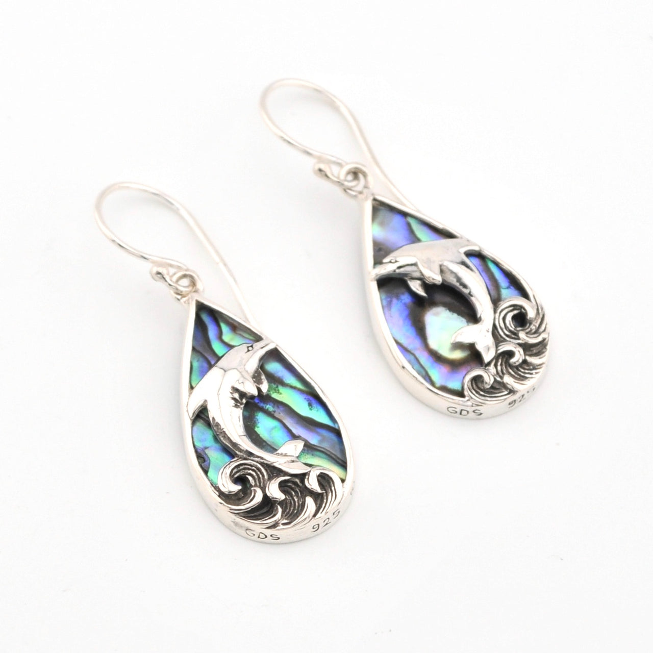 Teardrop-shaped earrings with abalone shell inlay and silver detailing on a white background