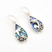 Teardrop-shaped earrings with abalone shell inlay and silver detailing on a white background