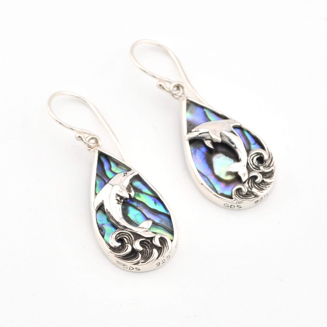 Teardrop-shaped earrings with abalone shell inlay and silver detailing on a white background