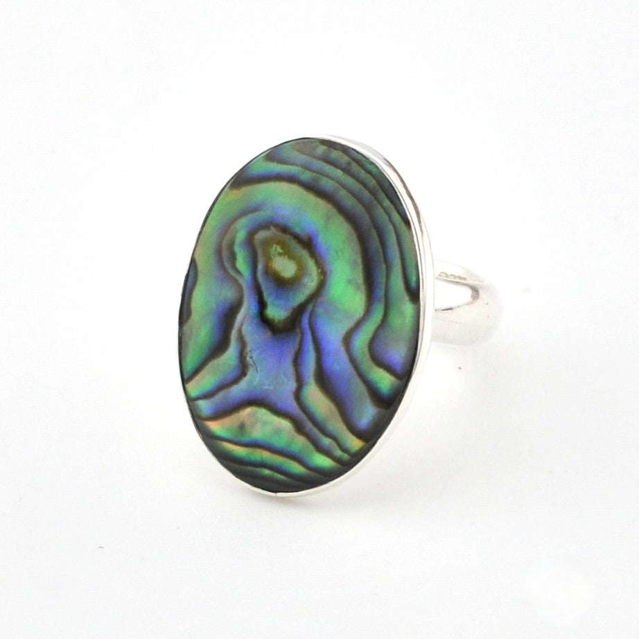 Ring with an abalone shell design on a white background