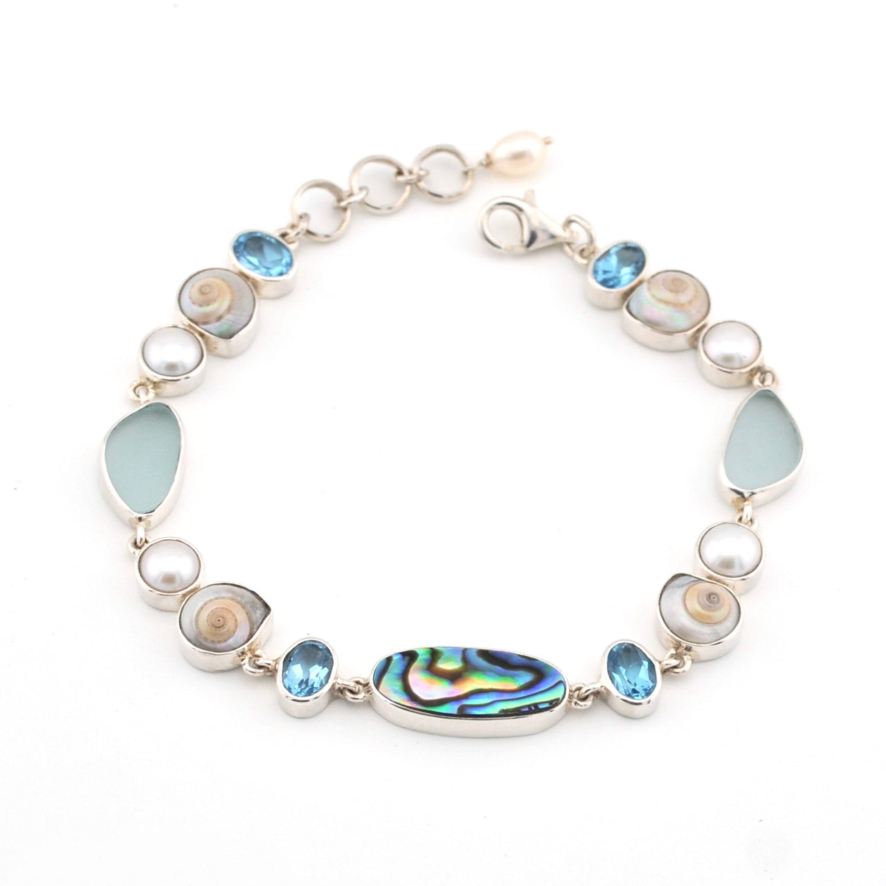 Bracelet with topaz, pearl, sea shell and sea glass on a white background