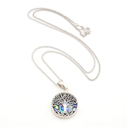 Silver necklace with a tree of life pendant on a white background