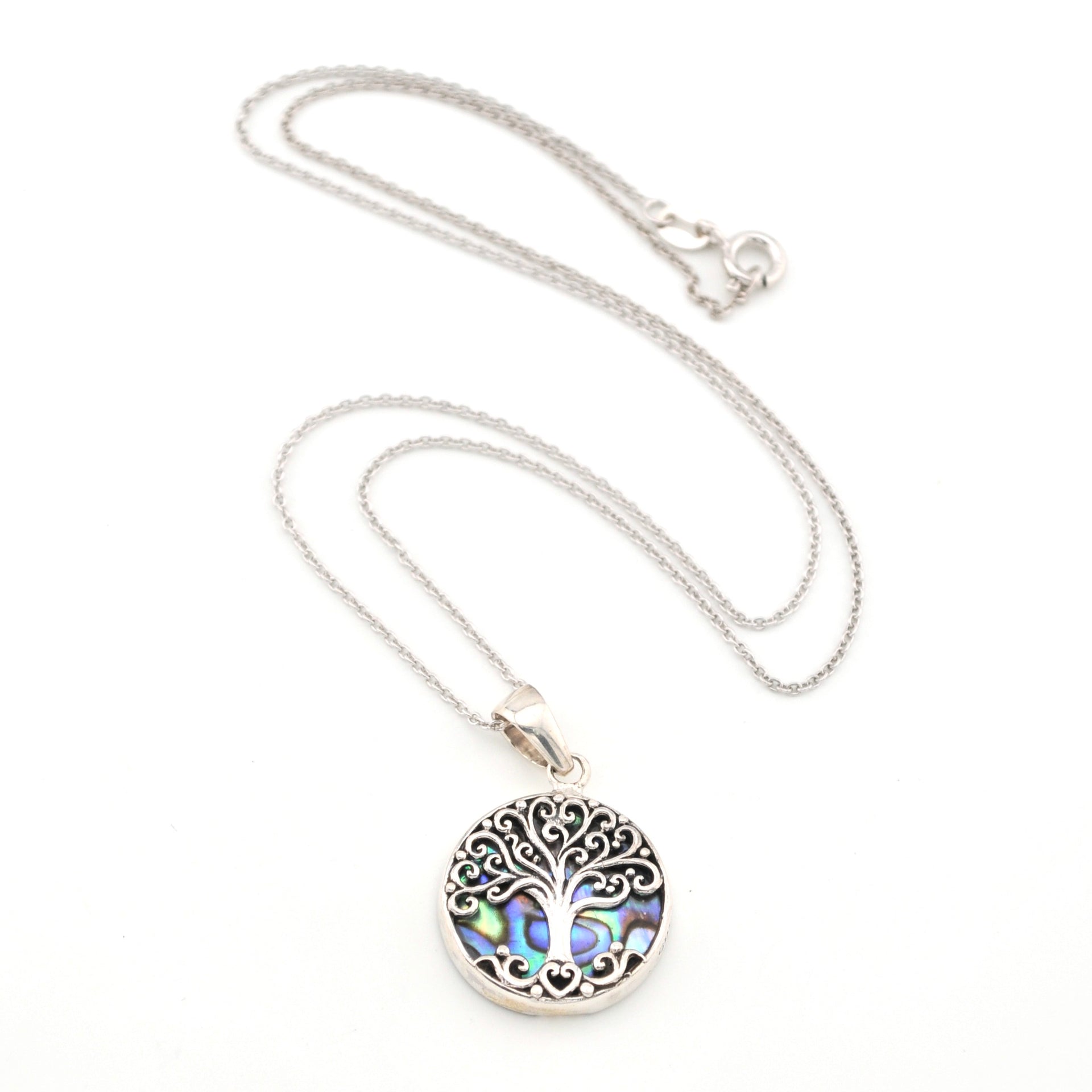 Silver necklace with a tree of life pendant on a white background